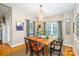 This dining room features a stylish light fixture, a wooden table, and natural light from the window at 133 Upland Dr, Statesville, NC 28625