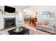 This living room showcases a fireplace, an armchair, and flows into an eat-in kitchen at 133 Upland Dr, Statesville, NC 28625