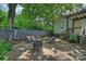 Private brick backyard patio includes modern outdoor seating and manicured landscaping at 1417 The Plz, Charlotte, NC 28205