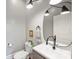 Stylish half bathroom with modern fixtures, including a sleek black faucet and oval mirror at 1417 The Plz, Charlotte, NC 28205