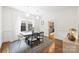 Elegant dining room featuring hardwood floors, statement lighting, and a view into the kitchen at 1417 The Plz, Charlotte, NC 28205