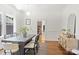 Dining room with neutral colors, hardwood floors, modern lighting, and adjacent kitchen view at 1417 The Plz, Charlotte, NC 28205