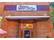 Exterior shot of Thomas Street Tavern featuring a large sign and inviting entrance at 1417 The Plz, Charlotte, NC 28205