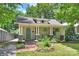 Home exterior with a brick walkway, blue door, covered porch, and well-maintained landscaping at 1417 The Plz, Charlotte, NC 28205