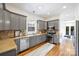 Well-equipped kitchen with stainless steel appliances, gray cabinetry, and granite countertops at 1417 The Plz, Charlotte, NC 28205