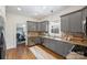A well-lit kitchen featuring gray cabinets, stainless steel appliances, and a wine cooler at 1417 The Plz, Charlotte, NC 28205