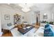 Open living room featuring a decorative light fixture, a bookshelf, and a comfortable seating area at 1417 The Plz, Charlotte, NC 28205