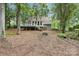 Spacious backyard view of a home with a deck and partially wooded landscaping at 1517 E Barden Rd, Charlotte, NC 28226