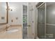 Bright bathroom with vanity, stone countertops, glass shower, and modern fixtures at 1517 E Barden Rd, Charlotte, NC 28226
