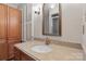 Well-lit bathroom with vanity, granite countertops, shuttered window, and wooden cabinetry at 1517 E Barden Rd, Charlotte, NC 28226
