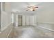Large bedroom offers neutral walls, carpet, large closet, and a ceiling fan at 1517 E Barden Rd, Charlotte, NC 28226