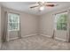 Bright bedroom with two windows, neutral walls, carpet and a modern ceiling fan at 1517 E Barden Rd, Charlotte, NC 28226