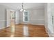 Dining room with hardwood floors, large window, and classic trim at 1517 E Barden Rd, Charlotte, NC 28226
