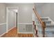 Welcoming entryway with hardwood floors and a staircase with wood banister at 1517 E Barden Rd, Charlotte, NC 28226