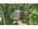 Aerial view of a charming two-story home with a lush yard and black shutters nestled among mature trees at 1517 E Barden Rd, Charlotte, NC 28226