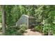 Charming two-story home with lush landscaping and black shutters nestled among mature trees at 1517 E Barden Rd, Charlotte, NC 28226