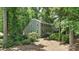 Charming two-story home with lush landscaping and black shutters nestled among mature trees at 1517 E Barden Rd, Charlotte, NC 28226