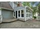 Exterior shot of home showcasing sunroom, deck and gray siding at 1517 E Barden Rd, Charlotte, NC 28226