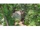 Aerial view of a charming two-story home with a lush yard and black shutters nestled among mature trees at 1517 E Barden Rd, Charlotte, NC 28226