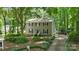 View of a two-story home with gray siding, black shutters, and mature landscaping at 1517 E Barden Rd, Charlotte, NC 28226