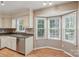 Kitchen featuring a sink, dishwasher and window bay at 1517 E Barden Rd, Charlotte, NC 28226