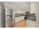 Kitchen featuring stainless steel appliances, white cabinets and wood flooring at 1517 E Barden Rd, Charlotte, NC 28226