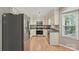 Kitchen featuring stainless steel appliances, neutral cabinets, and wood flooring at 1517 E Barden Rd, Charlotte, NC 28226