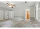 Spacious main bedroom featuring neutral paint, ceiling fan, and access to an attached bathroom at 1517 E Barden Rd, Charlotte, NC 28226