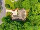 Aerial view of a home nestled among lush trees, showcasing its unique architectural details at 16527 Woolwine Rd, Charlotte, NC 28278