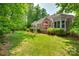 Expansive backyard with a deck, lush lawn, and landscaping providing serene outdoor space at 16527 Woolwine Rd, Charlotte, NC 28278