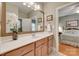 Bright bathroom with a large mirror, wooden cabinets, and a glimpse of the bedroom at 16527 Woolwine Rd, Charlotte, NC 28278