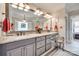 Stylish bathroom featuring dual sinks, granite countertops, and decorative mirrors at 16527 Woolwine Rd, Charlotte, NC 28278