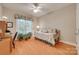Cozy bedroom with a daybed, wooden floors, and a window with natural light at 16527 Woolwine Rd, Charlotte, NC 28278