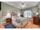 Comfortable bedroom featuring a ceiling fan and large window with natural lighting at 16527 Woolwine Rd, Charlotte, NC 28278