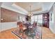 Elegant dining room with a large table, chandelier, wainscoting, and hardwood floors, great for entertaining at 16527 Woolwine Rd, Charlotte, NC 28278