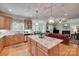 Spacious kitchen with a large island and a view to the dining and living areas at 16527 Woolwine Rd, Charlotte, NC 28278