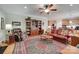 Inviting living room featuring a cozy leather sofa, wooden bookshelf, and ceiling fan at 16527 Woolwine Rd, Charlotte, NC 28278