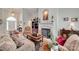 Cozy living room with a fireplace, hardwood floors, and comfortable seating, perfect for relaxation at 16527 Woolwine Rd, Charlotte, NC 28278