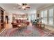 Spacious open-concept living room filled with natural light, a ceiling fan, and flowing into the kitchen at 16527 Woolwine Rd, Charlotte, NC 28278