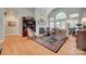 Bright living room with hardwood floors, fireplace, large windows, and comfortable seating at 16527 Woolwine Rd, Charlotte, NC 28278