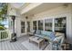 Comfortable back porch with an outdoor seating area, lake view, and a heater at 17719 Springwinds Dr, Cornelius, NC 28031