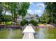 Back of the house with a private pier, seating, and picturesque lake views at 17719 Springwinds Dr, Cornelius, NC 28031