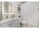 Well-lit bathroom with a modern vanity, drawers, and a shower-tub with a white curtain at 17719 Springwinds Dr, Cornelius, NC 28031