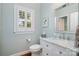 Tastefully designed bathroom featuring a marble vanity, a window with shutter, and a modern toilet at 17719 Springwinds Dr, Cornelius, NC 28031