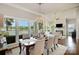 Open dining room with lake views from the large window, designer lighting, and an elegant, neutral palette at 17719 Springwinds Dr, Cornelius, NC 28031