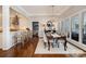 Elegant dining room with hardwood floors, chandelier lighting, and views of the modern kitchen at 17719 Springwinds Dr, Cornelius, NC 28031