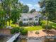 Stunning waterfront home featuring lush landscaping, a private dock, and a charming two-story facade at 17719 Springwinds Dr, Cornelius, NC 28031
