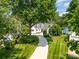 Stunning lakefront home with a beautifully landscaped front yard and circular driveway, offering curb appeal and convenient parking at 17719 Springwinds Dr, Cornelius, NC 28031