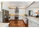 Modern kitchen boasts stainless steel appliances, white cabinetry, subway tile backsplash, and hardwood floors at 17719 Springwinds Dr, Cornelius, NC 28031