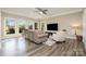 Open concept living room with hardwood floors and bright natural light at 17719 Springwinds Dr, Cornelius, NC 28031